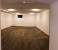 empty room, wooden floor, white walls, ceiling lights, small window