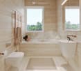 Modern bathroom with beige marble tiles, a freestanding bathtub, a sink with a modern faucet, a toilet, a towel rack with a towel, and a bathroom rug. Large windows offer a view of greenery outside.