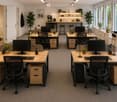 Furnished Room. Modern office space with multiple desks, chairs, computer monitors, and plants.