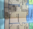 Floor plan showing a living area, kitchen, two bedrooms, bathroom, and balcony.