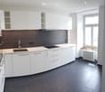 modern kitchen with white cabinets, black tiled floor, gas stove, sink, window with view