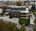 Modern house, large solar panels on the roof, swimming pool in the garden, garage, fenced garden, multiple balconies