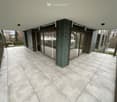 modern balcony, large glass walls, tiled floor, balcony railings, garden view