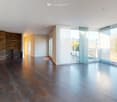 tiled floor, large windows, glass doors to balcony, stone wall