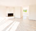 Empty hallway with tiled floor, white walls, and a built-in fireplace on one side.