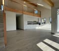 open floor plan, kitchen, balcony, stairs, large windows