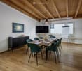 modern meeting room with wooden floor, white walls, wooden ceiling, large windows, table, chairs, TV, whiteboard, cabinet, artwork
