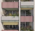 Modern multi-story building with balconies, green and yellow accents, and small plants on each balcony.