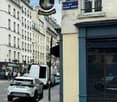 Street scene with vehicles, shopfronts, and pedestrians