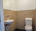 A small bathroom with a sink and toilet.