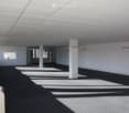 Empty room with white walls, carpeted floor, large windows, and white ceiling panels. No furniture or equipment visible.