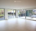 large room with balcony, large windows, tile flooring, empty room