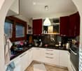 {"type": "Kitchen", "objects": ["sink", "faucet", "oven", "stove", "cabinets", "cupboard", "fridge", "cup", "bowl", "frying pan", "oven", "cupboard", "cupboard", "cupboard", "cupboard", "cupboard", "cupboard", "cupboard", "cupboard", "cupboard", "cupboard