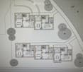 Floor plan showing multiple rooms including living areas, dining areas, bedrooms, and bathrooms. The layout includes labeled dimensions and room designations.