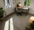 Bright, modern home office with large windows, wooden flooring, a desk with a laptop, a chair, a lamp, and decorative plants.