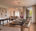 Modern living and dining area with a grey sofa, coffee table, dining table with chairs, table lamp, flower vase, and artwork on the wall.