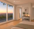 Bright bedroom with wooden flooring, large windows opening to a balcony with city view, side table with lamp, potted plant, and decorative candle holder.