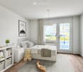 Cozy children's bedroom with a white bed, nightstand, shelves, and toys. Features a large window with a view and a sliding glass door leading to a balcony.