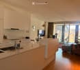 {"visible_features": ["Balcony / Terrace"], "type": "Furnished Room", "objects": ["sofa", "coffee table", "chair", "table", "kitchen island", "sink", "faucet", "faucet", "faucet", "faucet", "faucet", "faucet", "faucet", "faucet", "faucet", "faucet", "fauc