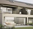 Modern two-story house with solar panels, large glass doors, balcony, and outdoor seating area