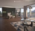 Modern living room with hardwood flooring, large windows, a white sofa, glass coffee table, and a dining area with white chairs and a round table.