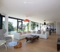 modern living room, white sofa, wooden coffee table, glass side table, armchair, TV, large windows
