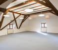Exposed wooden beams, wooden flooring, large windows, carpeted floor, 4 hanging lamps