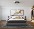 Modern bedroom with a large bed, nightstands, lamps, artwork, and a wooden wardrobe with glass doors.