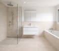 modern bathroom with shower, bathtub, sink, mirror, beige tiles