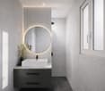 Modern bathroom with a white sink, dark grey cabinet, round mirror, and vase with dried flowers on the counter.