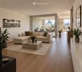 Modern living room with light wooden flooring, large sectional sofa, coffee table, side table, and plants. Large windows offer a city view.