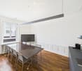 modern interior, wooden floor, rectangular dining table, chairs, TV, radiator, countertop, sink