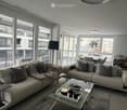 two couches, glass table, two lamp bases, dining table, two windows