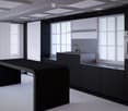 Modern kitchen with sleek black cabinets, a central island table, and a sink with a faucet. Large windows with white curtains provide natural light.