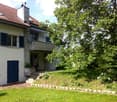 2 story house, red roof, white walls, blue shutters, balcony, garden, tree