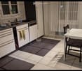 Modern kitchen with white cabinets, stainless steel appliances, a dining table with chairs, and a curtained window.