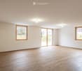Empty room, hardwood floors, white walls, large windows, sliding glass door