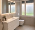 Modern bathroom with a white sink, chrome faucet, large mirror with LED lighting, toilet, and decorative items on the sink counter.