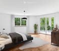 Modern bedroom with a large bed, nightstand, lamps, potted plants, and a side table near the window. The room features wooden flooring, white walls, and large windows with sheer curtains.