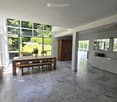 Bright, open dining area with a wooden dining table, bench seating, and chairs. Large windows provide natural light, and the space features a marble floor, a wooden cabinet, and a modern counter with a mirror.