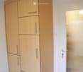 Large wooden wardrobe with multiple drawers and compartments