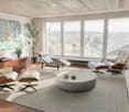 Modern living room with large windows, white leather sofa, coffee table, chairs, ottomans, and artwork.