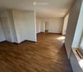 empty room, wooden floor, white walls, white doors, windows, radiator