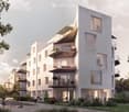 Modern multi-story residential building with balconies, large windows, and contemporary design. The building features a mix of light-colored facades and glass elements, surrounded by greenery and a paved walkway.