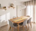 Dining room with a wooden dining table, six grey chairs, a yellow and grey table runner, a potted plant, and decorative items on a shelf.