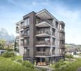 Modern multi-story residential building with balconies, large windows, and a scenic mountain view in the background.