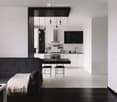 Modern open-plan living and dining area with a black sofa, coffee table, dining table with chairs, and a sleek kitchen area with cabinets, appliances, and a sink.