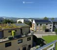 A modern residential complex with multiple buildings, green roofs, balconies, and surrounding greenery.