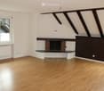 wooden floor, empty room, brick fireplace, white walls, radiator, window with blinds