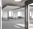 Modern, minimalist meeting room with grey carpet, large windows, grey tables, and chairs arranged in rows.